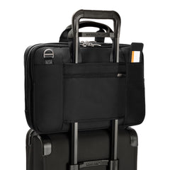 Briggs & Riley Medium Expandable Briefcase in black, showcasing a sleek design with multiple compartments and a sturdy handle.