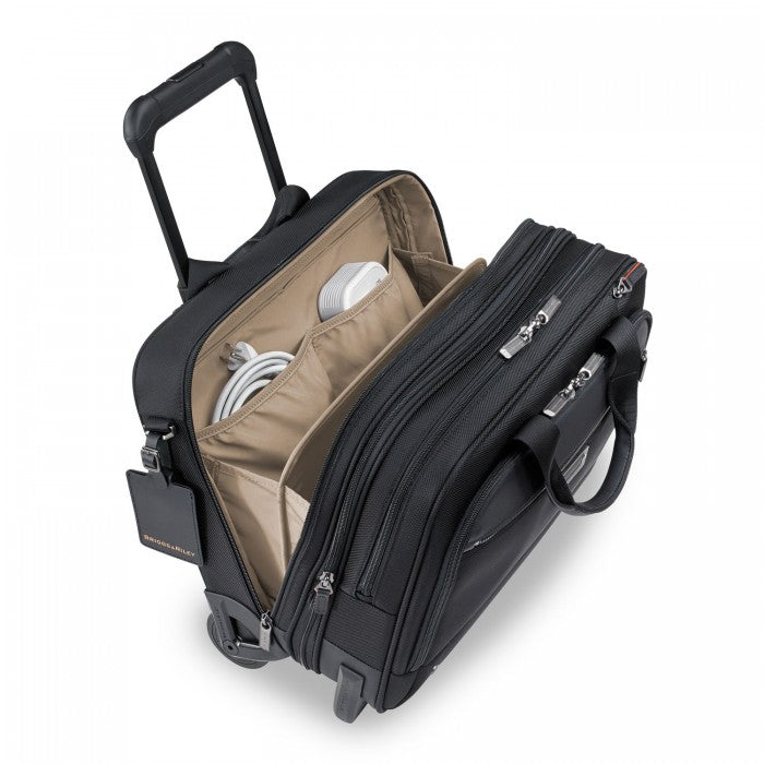 Briggs & Riley black medium expandable briefcase with multiple compartments and adjustable straps, displayed from the front.