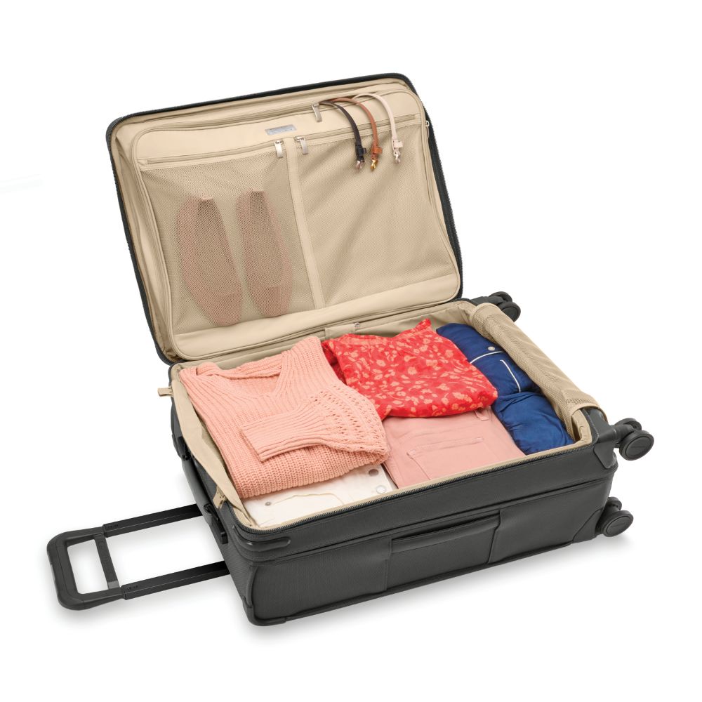Briggs & Riley Baseline 2 medium expandable spinner suitcase in black, featuring wheels and spacious interior for travel.