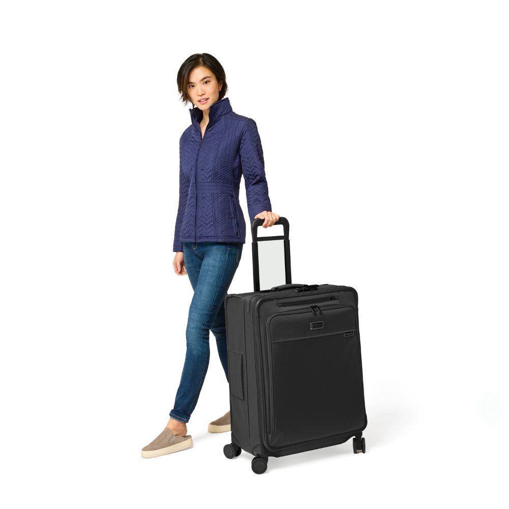 Briggs & Riley Baseline 2 medium expandable spinner suitcase in black, showcasing durable exterior and spacious interior.