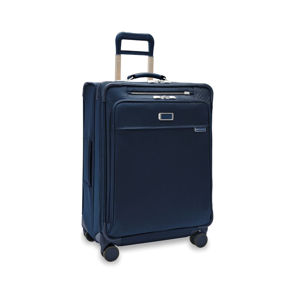 Briggs & Riley Baseline 2 medium expandable spinner suitcase in navy, featuring four wheels and a sturdy handle.