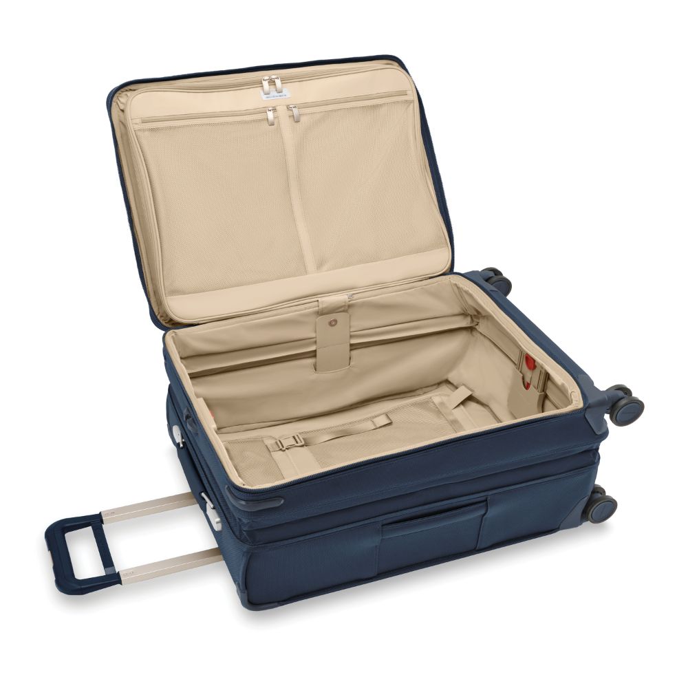 Navy medium expandable spinner suitcase from Briggs & Riley, featuring durable design and smooth-rolling wheels.