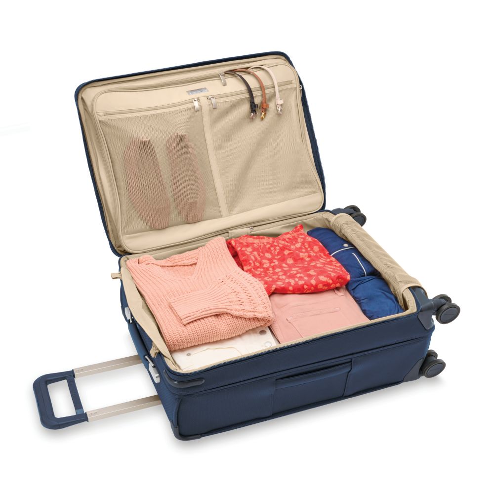 Briggs & Riley Baseline 2 medium expandable spinner suitcase in navy, featuring smooth wheels and a durable exterior.