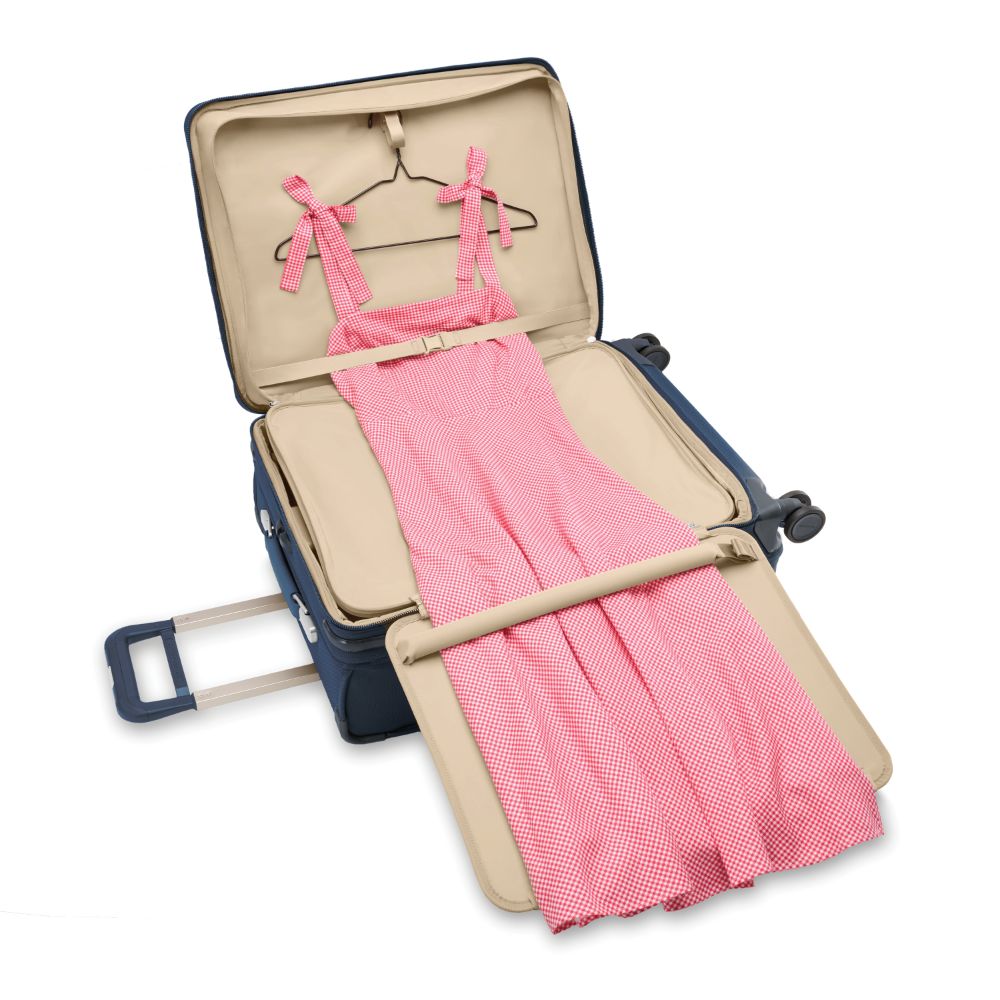 Navy Briggs & Riley Baseline 2 medium expandable spinner suitcase with smooth wheels and sturdy handle.