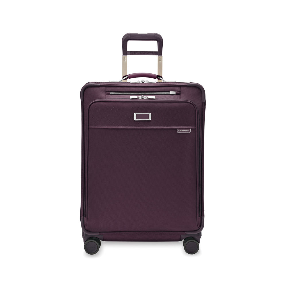 Briggs & Riley Baseline 2 medium expandable spinner suitcase in plum color with smooth wheels and sturdy handle.