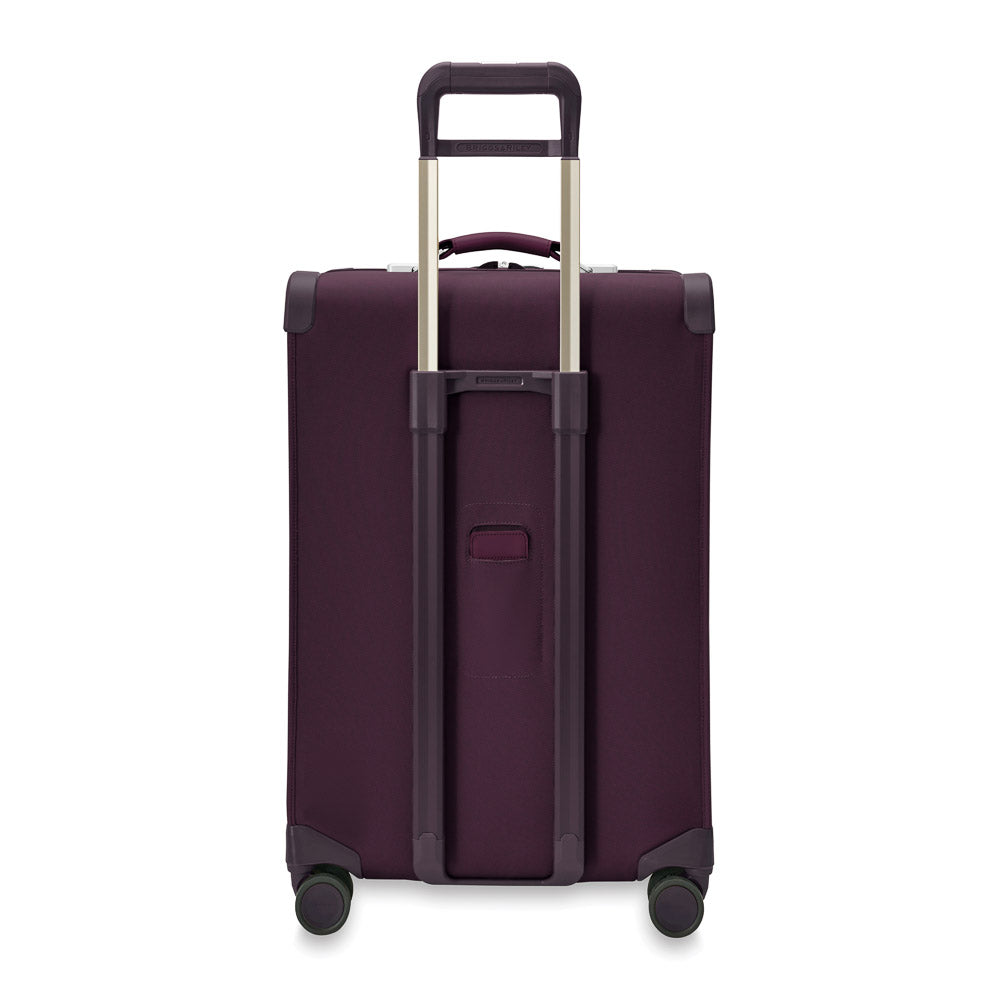 Briggs & Riley Baseline 2 medium expandable spinner suitcase in plum color with wheels and telescoping handle.