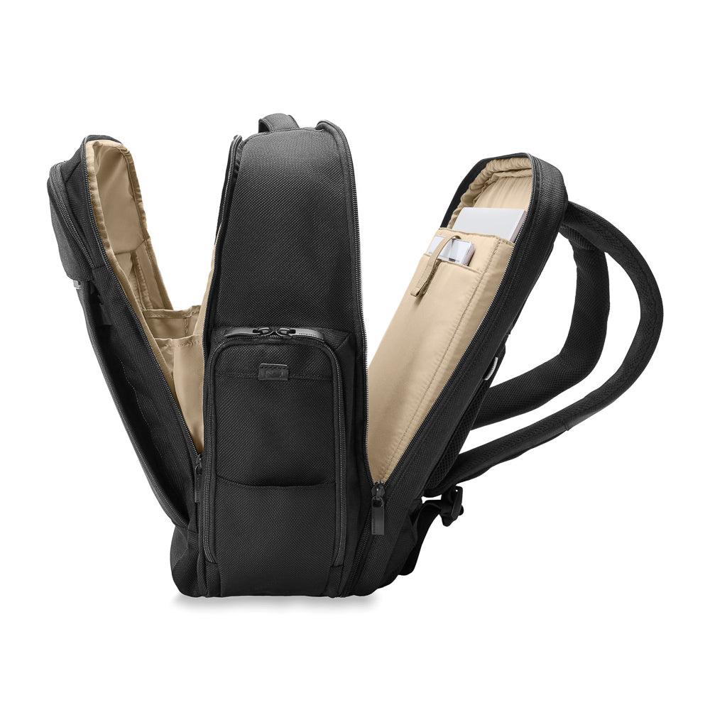 Black Briggs & Riley Baseline 2 Travel Backpack with multiple compartments and ergonomic straps, ideal for travel.