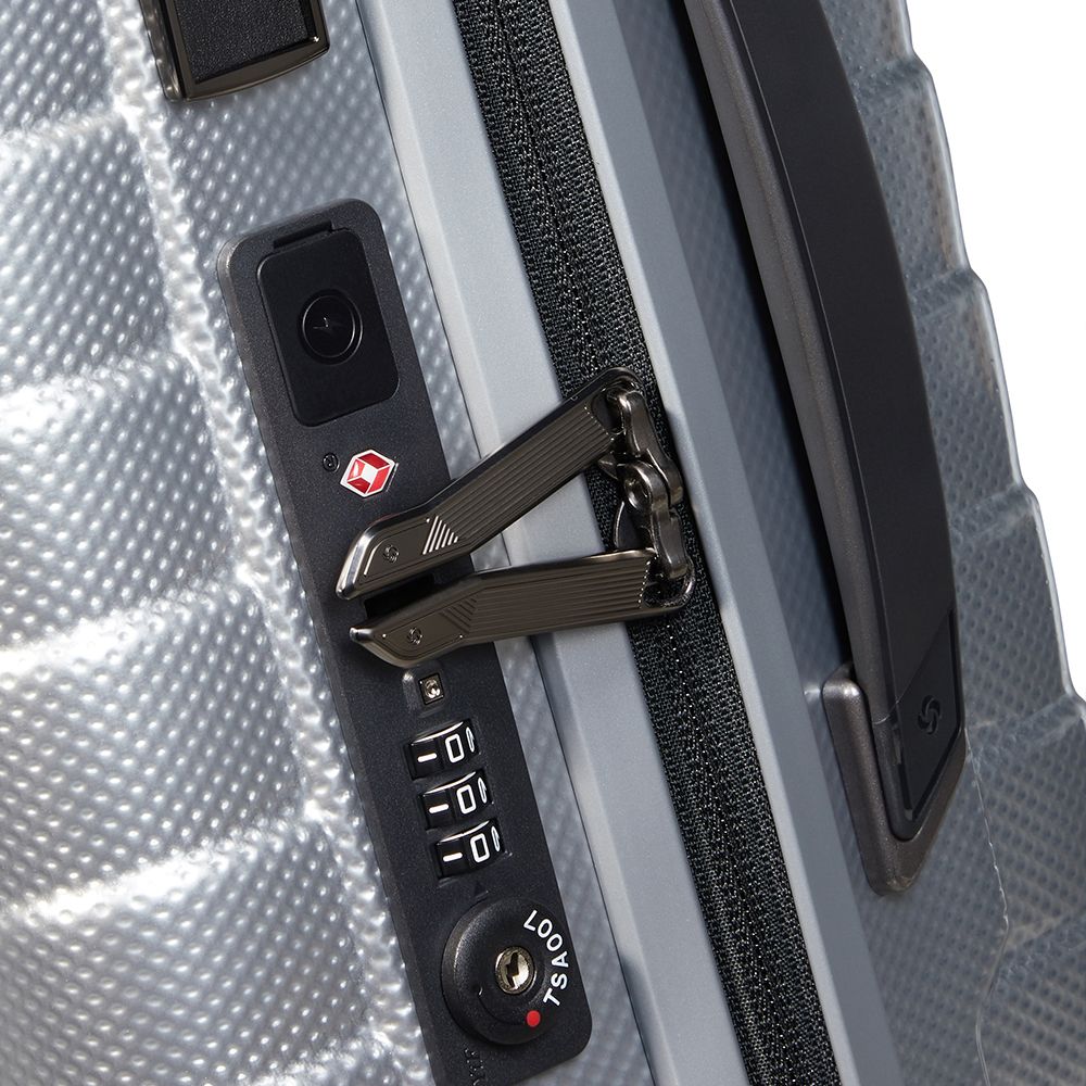 Samsonite Proxis 55cm expandable cabin spinner suitcase in silver with 360-degree wheels and sturdy handle.