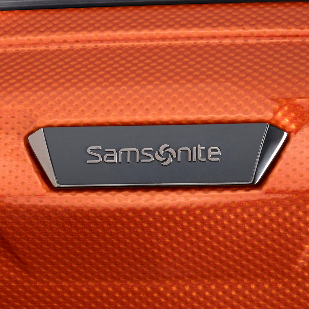 55cm expandable cabin spinner suitcase in flame color by Samsonite, featuring smooth wheels and durable design.