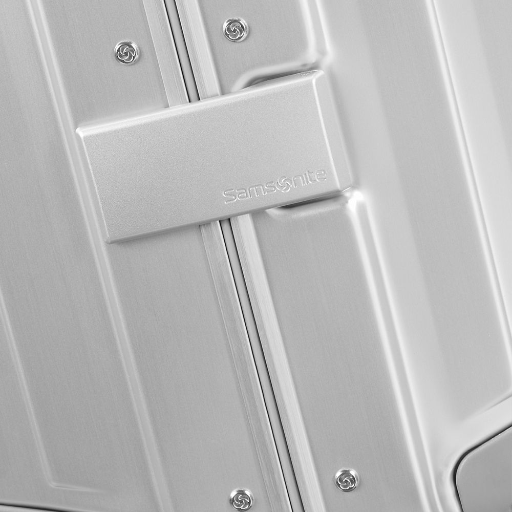 Samsonite Litebox 74cm trunk suitcase in aluminum with a sleek design and sturdy handle for check-in luggage travel.