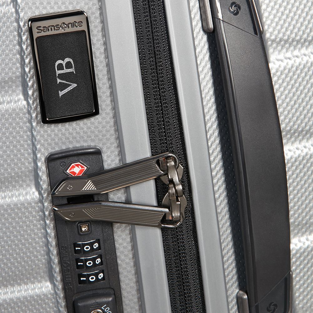 Silver 75cm Proxis spinner suitcase by Samsonite, showcasing its durable exterior and 360-degree rotating wheels.