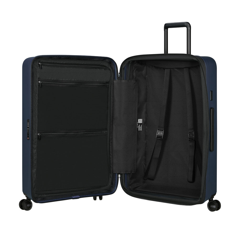 Samsonite Restackd 75cm spinner suitcase in midnight blue, featuring four wheels and a spacious interior for travel.