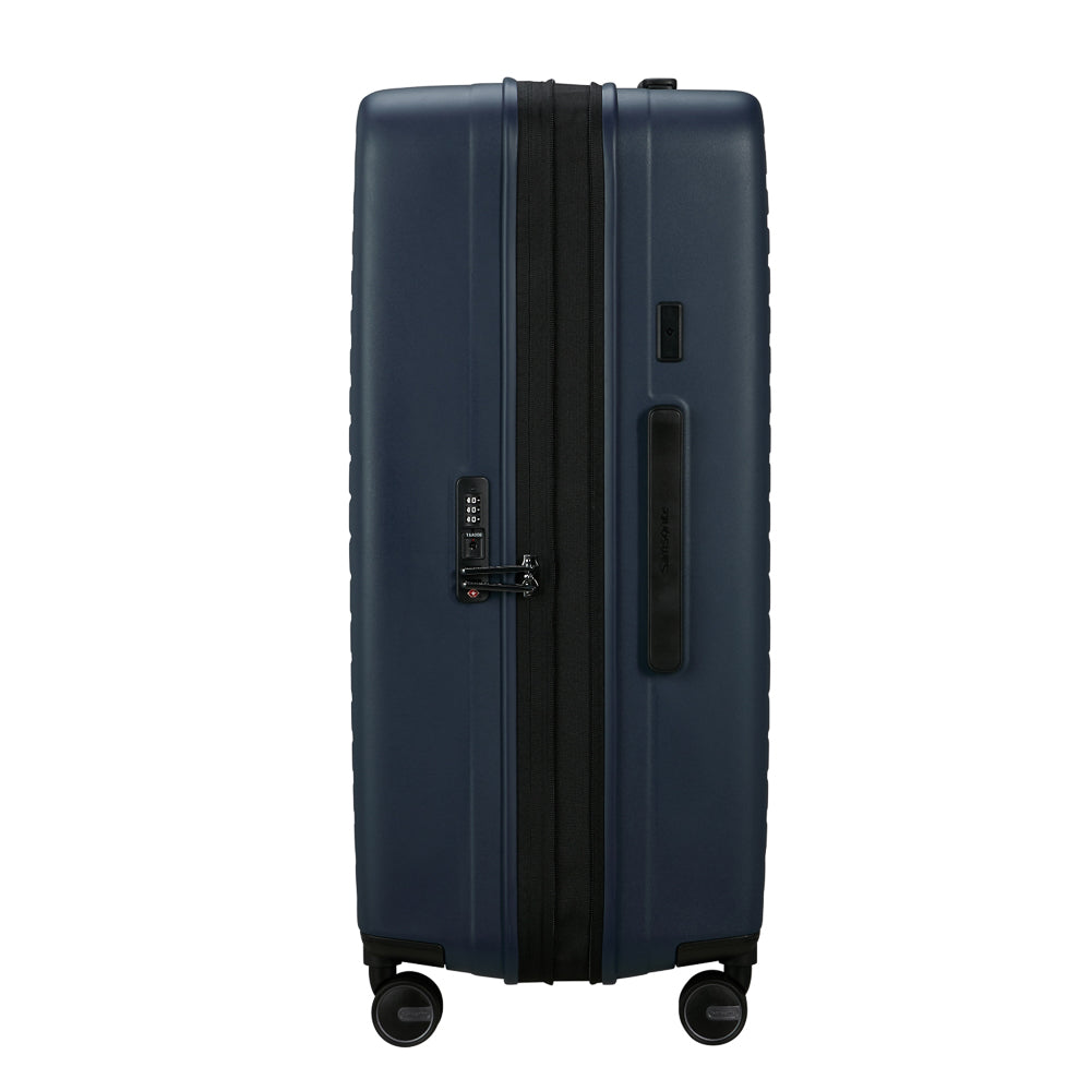 75cm Restackd spinner suitcase in midnight blue by Samsonite, showcasing durable wheels and spacious interior for check-in luggage.