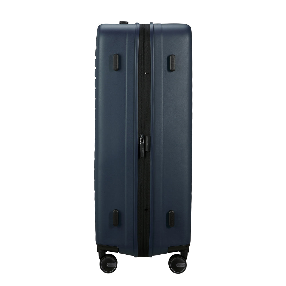Samsonite Restackd 75cm spinner suitcase in midnight blue, showcasing its durable exterior and smooth-rolling wheels.