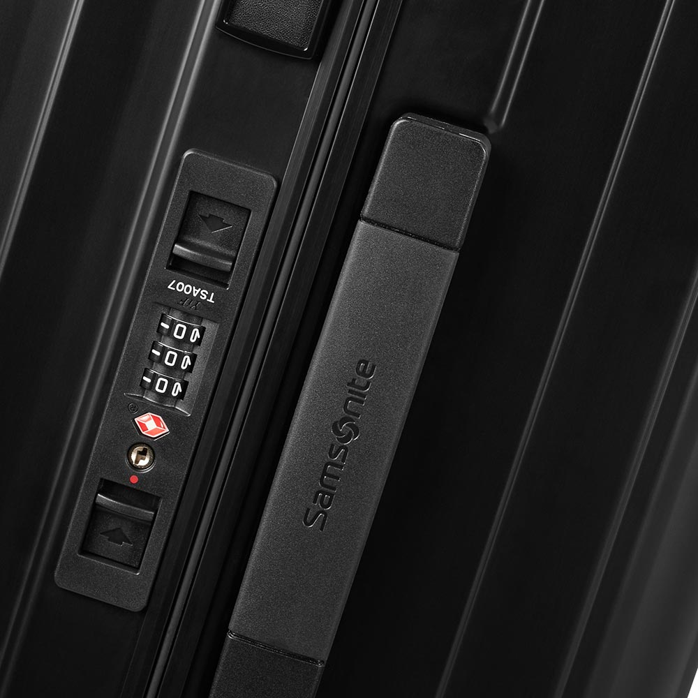 Black 76cm Samsonite Lite-Box Aluminium spinner suitcase with smooth wheels and sleek design for stylish travel.