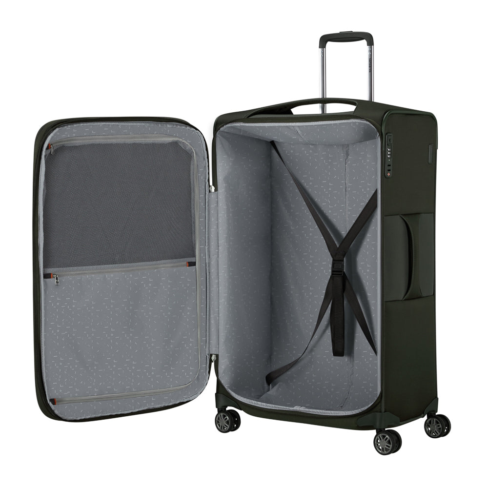 Green Samsonite Re-Lite 78cm expandable spinner suitcase with four wheels and a sturdy handle, perfect for check-in luggage.
