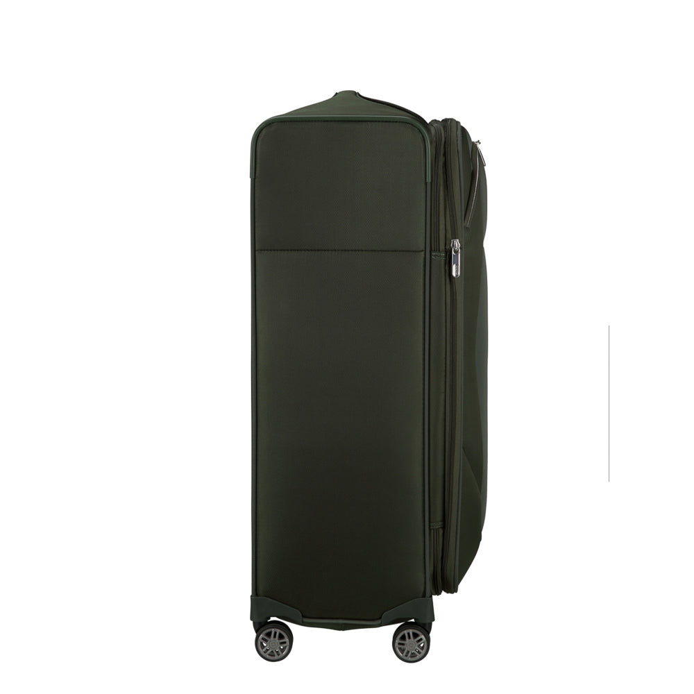 Green 78cm Samsonite Re-Lite expandable spinner suitcase with four wheels, perfect for check-in luggage.