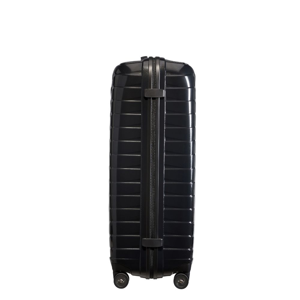 Black 81cm Samsonite Proxis spinner suitcase with four wheels and a sleek design, ideal for check-in luggage.