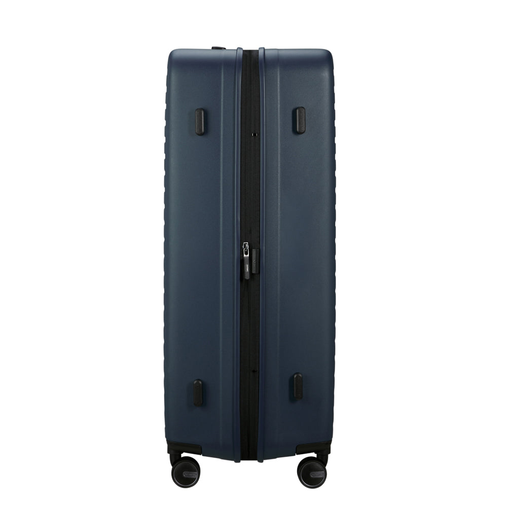 81cm Restackd Spinner Suitcase by Samsonite in midnight blue, showcasing wheels and expandable design for travel convenience.