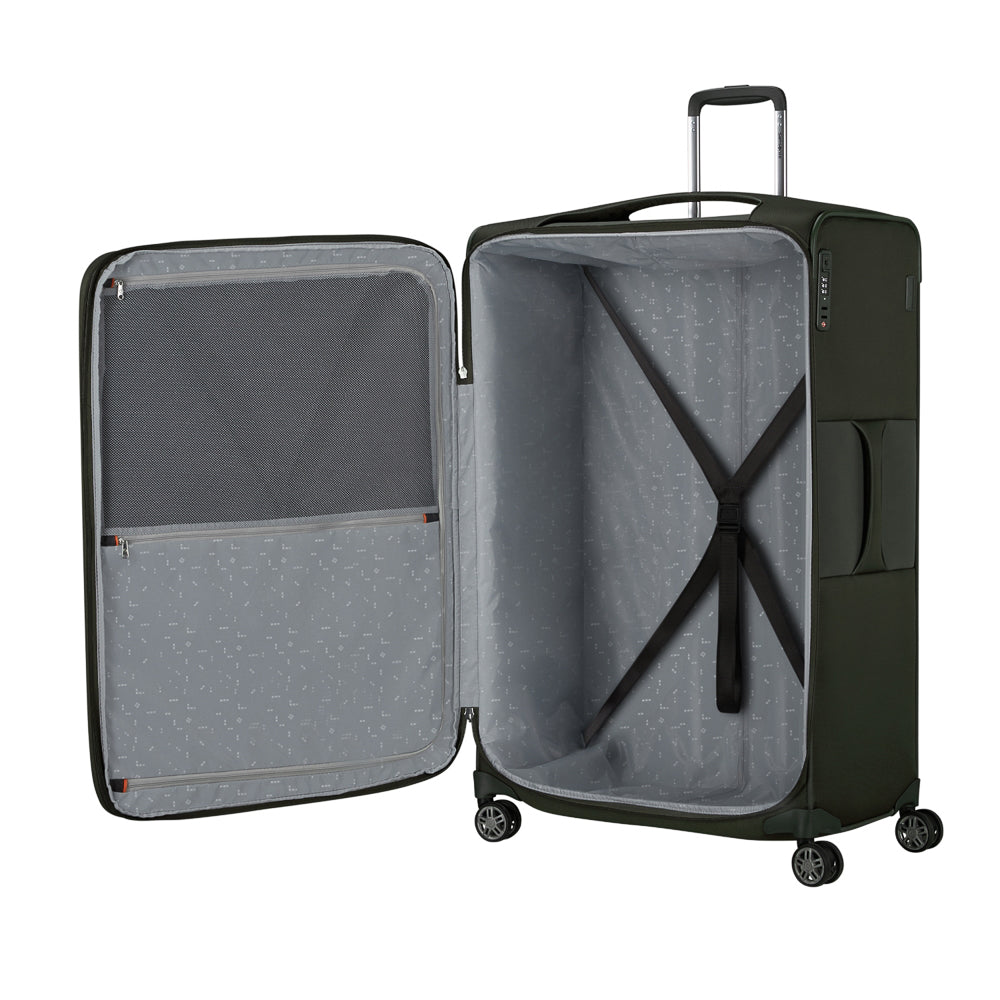 Green 83cm expandable spinner suitcase from Samsonite, featuring smooth wheels and a durable design for check-in travel.