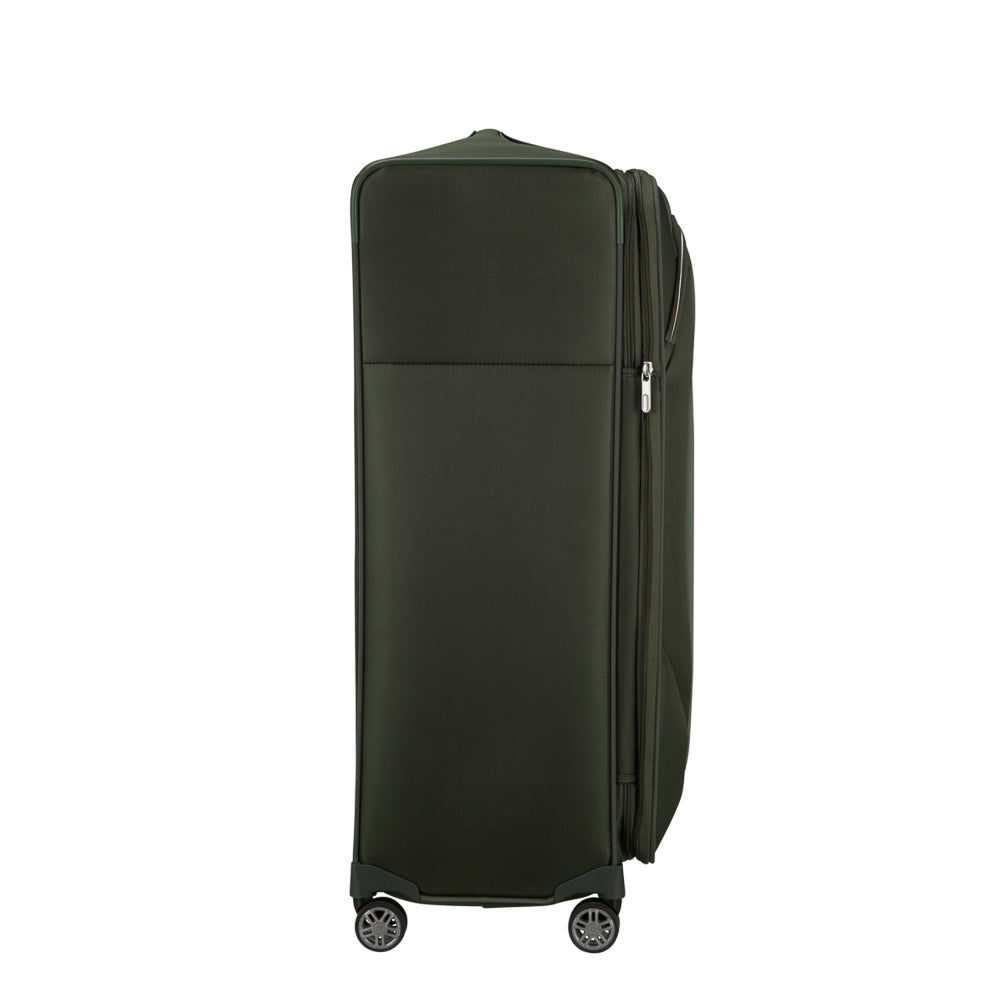 Samsonite Re-Lite 83cm expandable spinner suitcase in green, showcasing wheels and spacious interior for travel convenience.